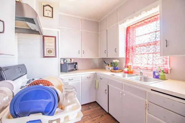 a kitchen with a sink cabinets and window