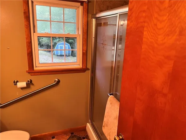a bathroom with a toilet and a shower