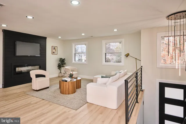 a living room with dining room and wooden floor