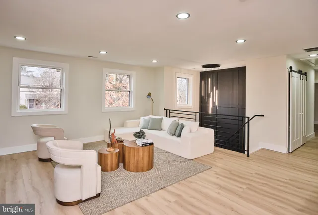 a living room with furniture and a wooden floor