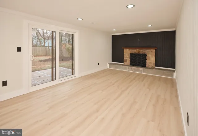 a view of hallway with a large window and wooden floor