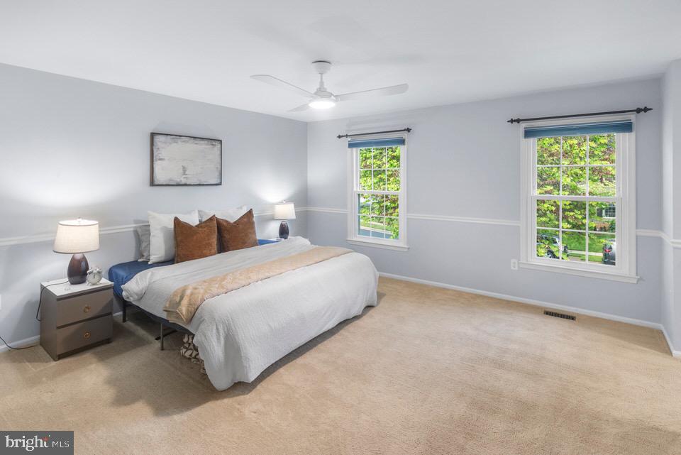 13338 Point Rider Lane Herndon, VA 20171 - Photo 18 of 36 a bedroom with a bed and a large window