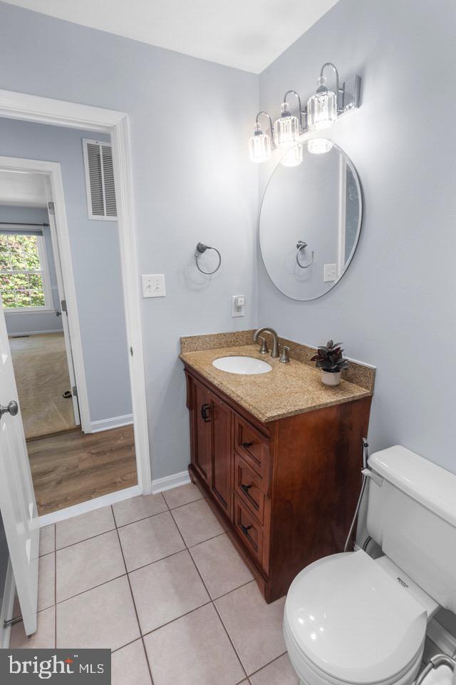 13338 Point Rider Lane Herndon, VA 20171 - Photo 23 of 36 a bathroom with a sink mirror vanity and toilet