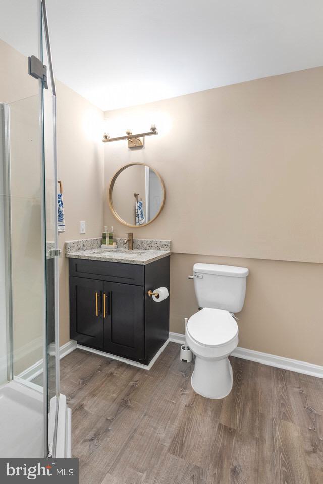13338 Point Rider Lane Herndon, VA 20171 - Photo 30 of 36 a bathroom with a granite countertop toilet a sink and a mirror