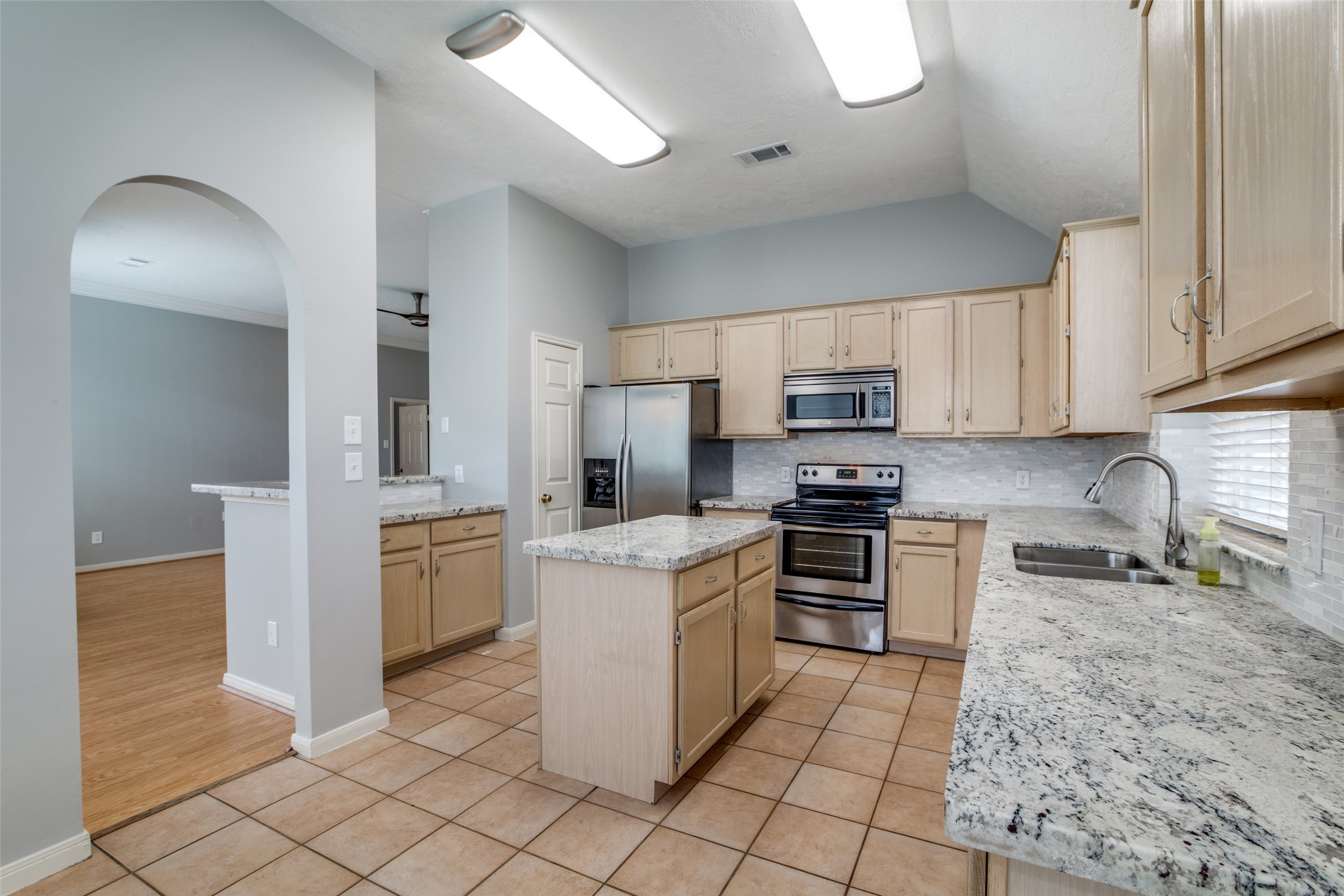 9331 Rodgers Road Houston, TX 77070 - Photo 12 of 25 a kitchen with cabinets and steel stainless steel appliances