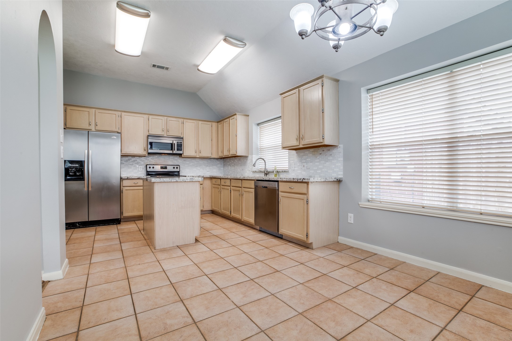 9331 Rodgers Road Houston, TX 77070 - Photo 13 of 25 a kitchen with stainless steel appliances granite countertop a stove a sink and a refrigerator