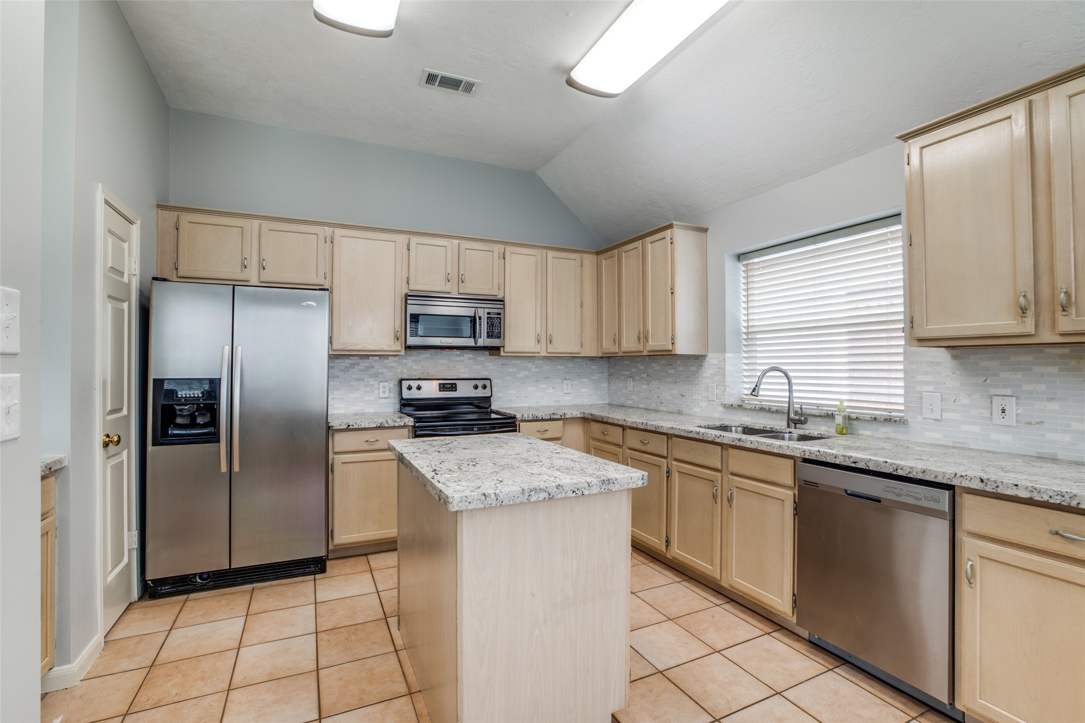 9331 Rodgers Road Houston, TX 77070 - Photo 14 of 25 a kitchen with stainless steel appliances granite countertop a stove a sink dishwasher a refrigerator and a microwave