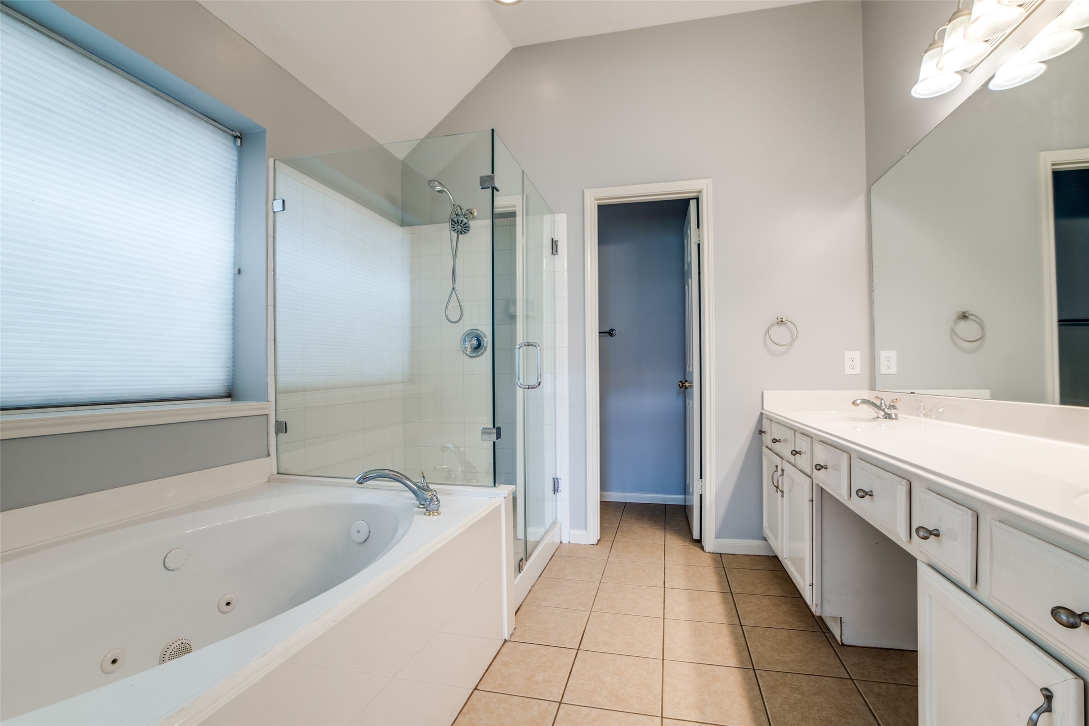 9331 Rodgers Road Houston, TX 77070 - Photo 18 of 25 a spacious bathroom with a bathtub sink and mirror
