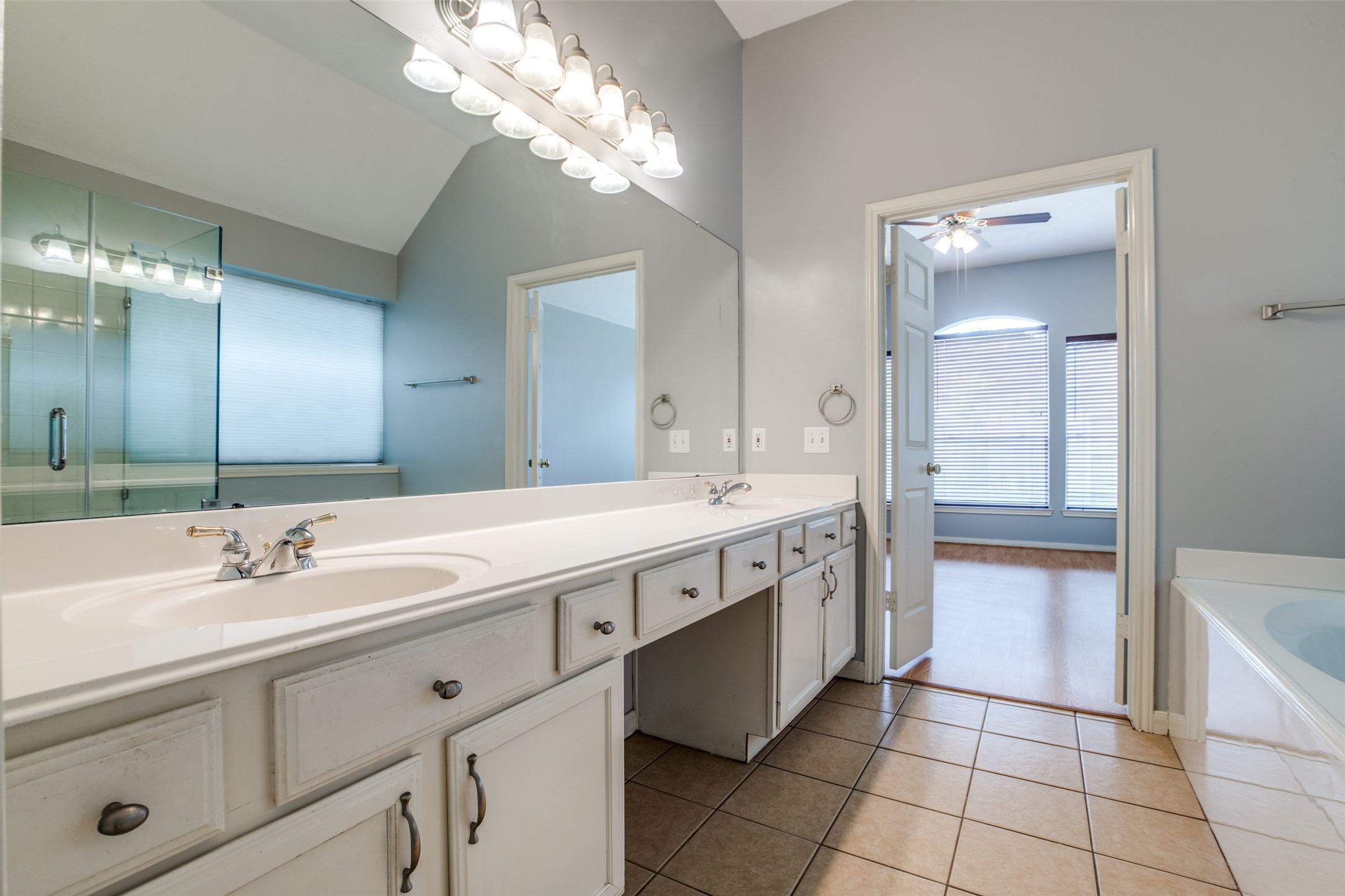 9331 Rodgers Road Houston, TX 77070 - Photo 20 of 25 a spacious bathroom with a double vanity sink a mirror and a bathtub
