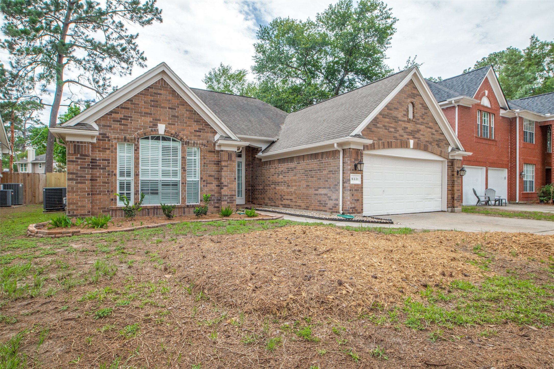 9331 Rodgers Road Houston, TX 77070 - Photo 2 of 25 a view of a yard in front of a house with a large tree