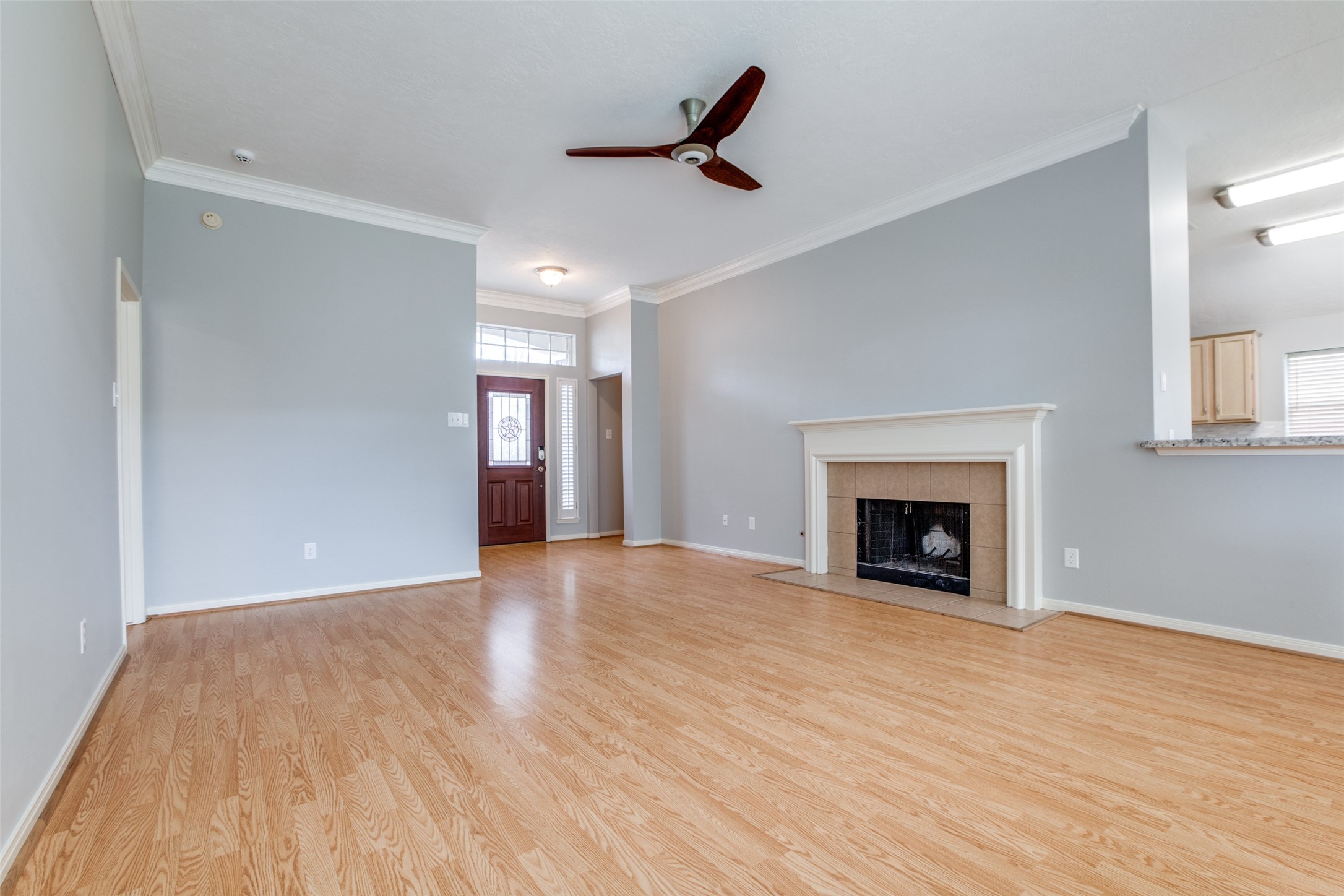 9331 Rodgers Road Houston, TX 77070 - Photo 4 of 25 a view of empty room with wooden floor and a fireplace