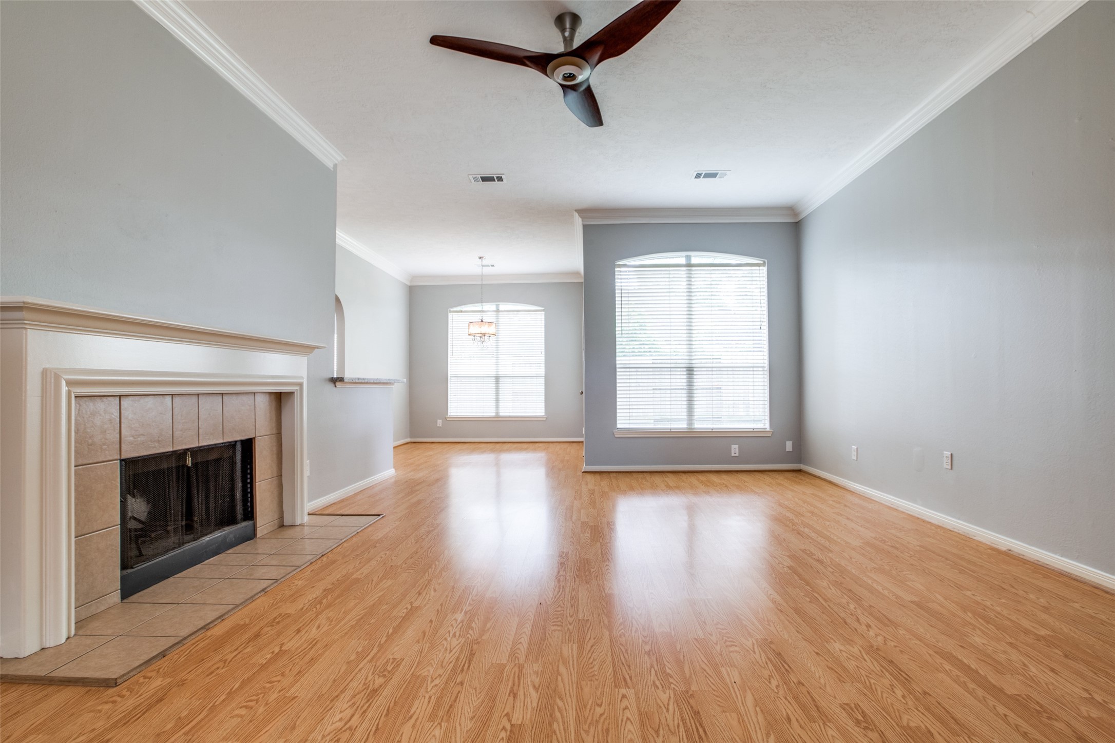 9331 Rodgers Road Houston, TX 77070 - Photo 8 of 25 an empty room with wooden floor fireplace and windows