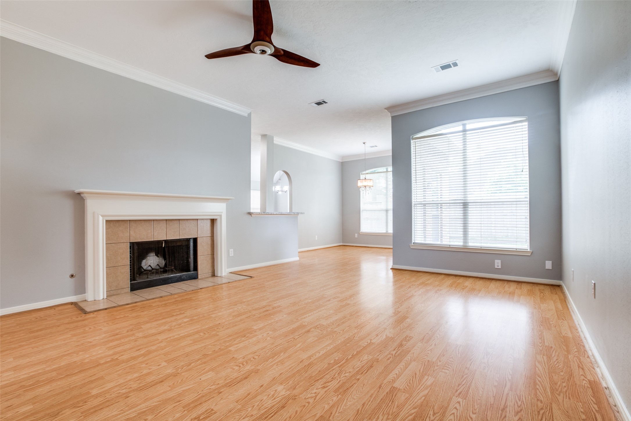 9331 Rodgers Road Houston, TX 77070 - Photo 9 of 25 a view of an empty room with wooden floor fireplace and a window
