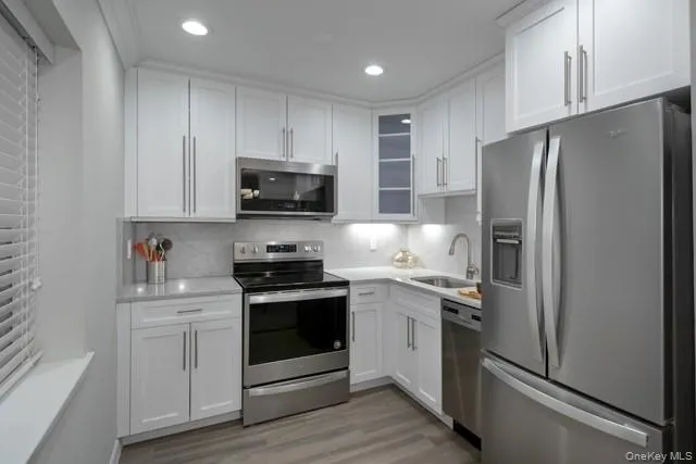 a kitchen with stainless steel appliances a refrigerator stove and sink