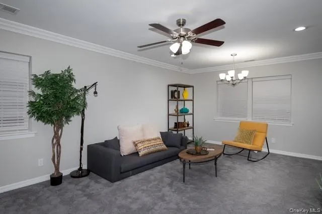 a living room with furniture and a potted plant