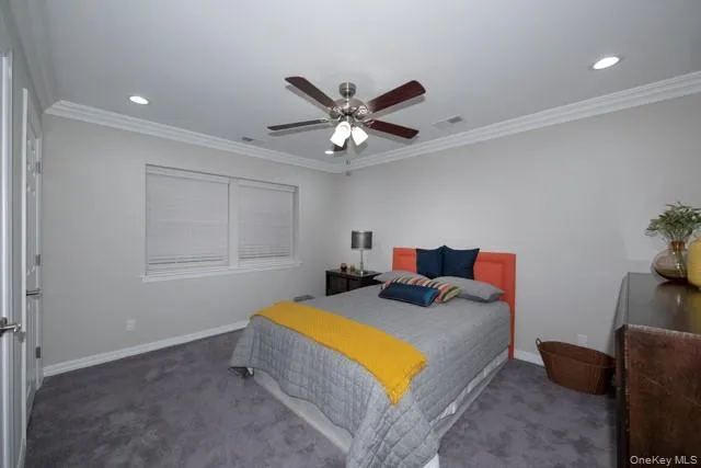 a bedroom with a bed and a ceiling fan