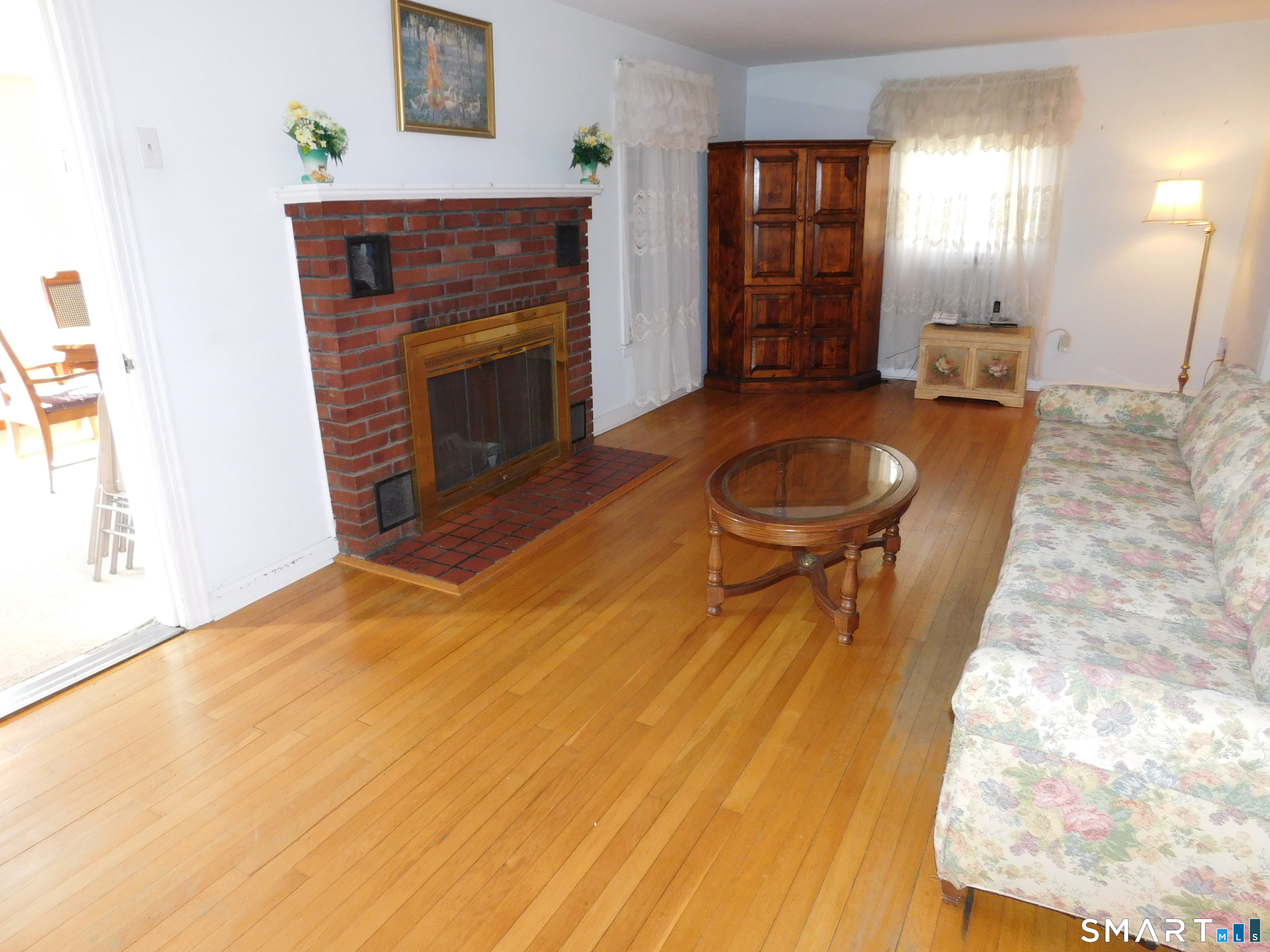 60 E Street Derby, CT 06418 - Photo 12 of 30 a living room with a fireplace furniture and a ceiling fan