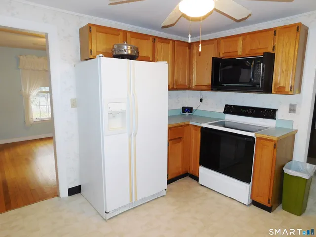 a kitchen with stainless steel appliances a refrigerator a stove a microwave a sink and cabinets