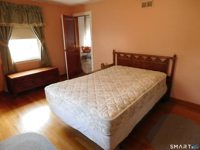 a bed sitting in a bedroom next to a window