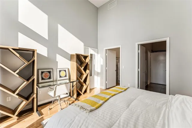 a bed room with a bed and a mirror