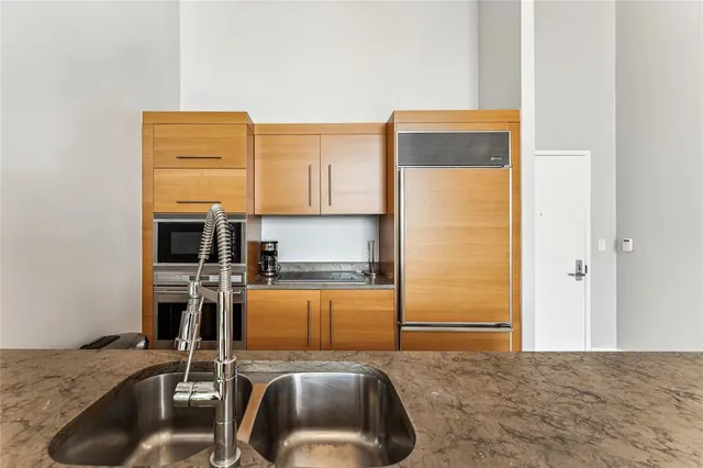 a kitchen with a refrigerator sink and stove