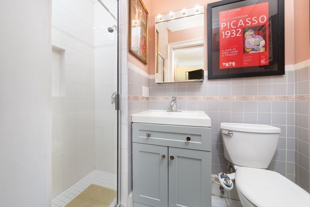 362 Commonwealth Avenue, Unit 2E 2F Boston, MA 02115 - Photo 12 of 17 a bathroom with a toilet sink and mirror