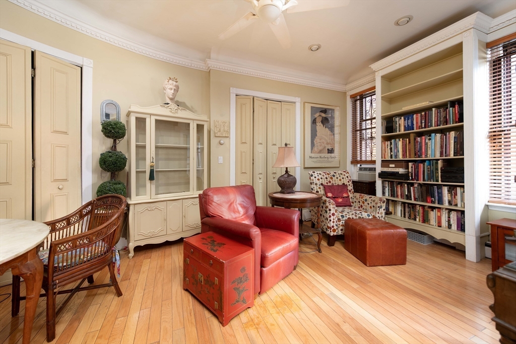 362 Commonwealth Avenue, Unit 2E 2F Boston, MA 02115 - Photo 6 of 17 a living room with furniture a rug and a book shelf