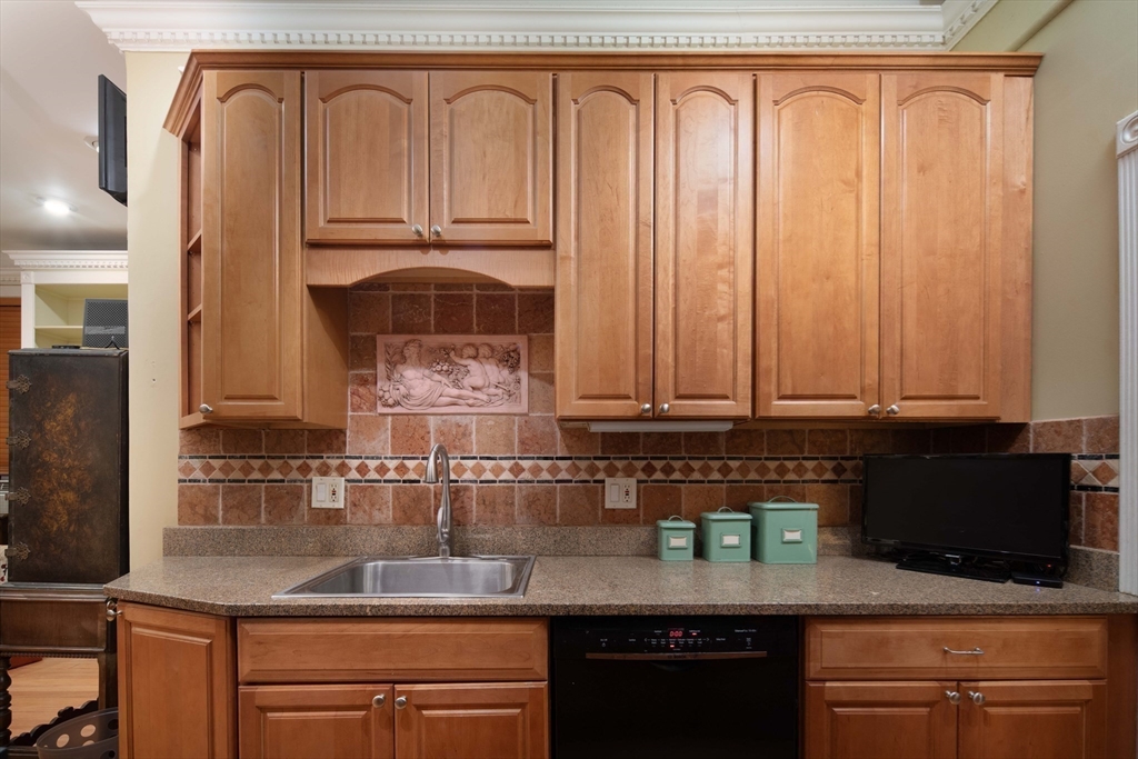 362 Commonwealth Avenue, Unit 2E 2F Boston, MA 02115 - Photo 7 of 17 a kitchen with granite countertop a sink a stove and cabinets