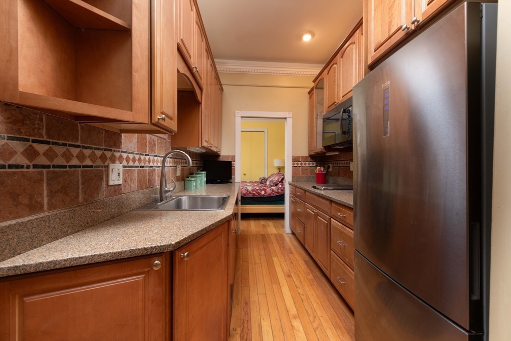 362 Commonwealth Avenue, Unit 2E 2F Boston, MA 02115 - Photo 7 of 17 a kitchen with a sink and a refrigerator