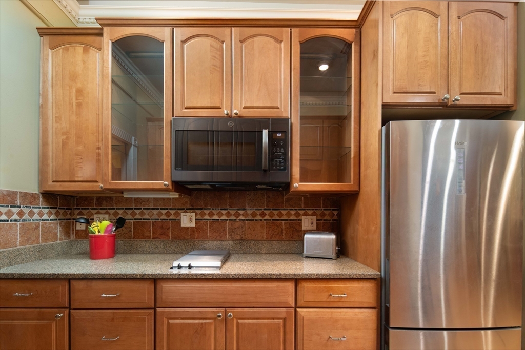 362 Commonwealth Avenue, Unit 2E 2F Boston, MA 02115 - Photo 9 of 17 a kitchen with granite countertop a refrigerator and a sink