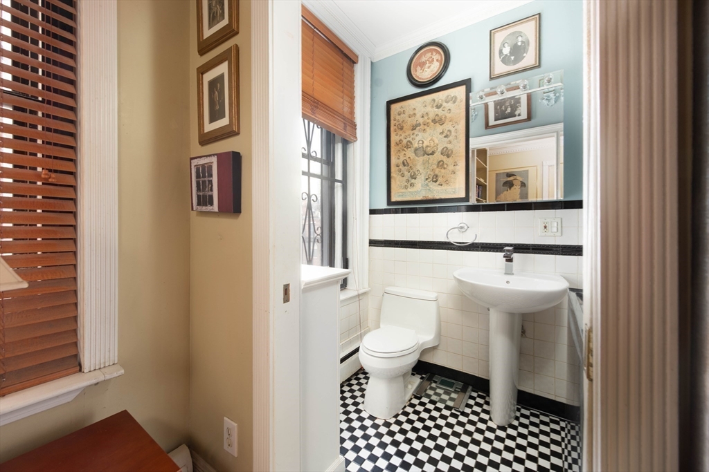 362 Commonwealth Avenue, Unit 2E 2F Boston, MA 02115 - Photo 10 of 17 a bathroom with a toilet a sink and a mirror