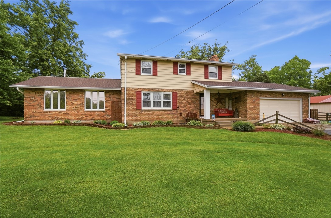 4170 Johnson Road Springfield, OH 45502 - Photo 7 of 54 A classic brick and siding home with a welcoming covered front porch and integrated garage.