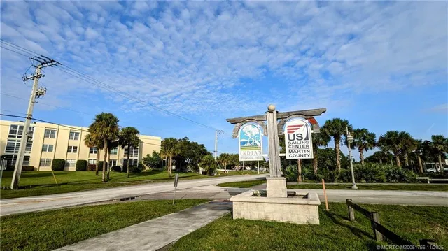 a view of a swimming pool with a garden and patio