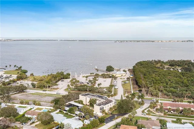 a view of a big room with wooden floor and windows