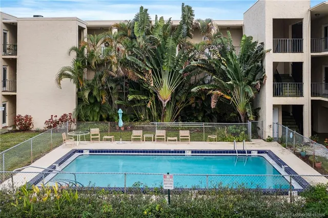 a view of a swimming pool with a bench