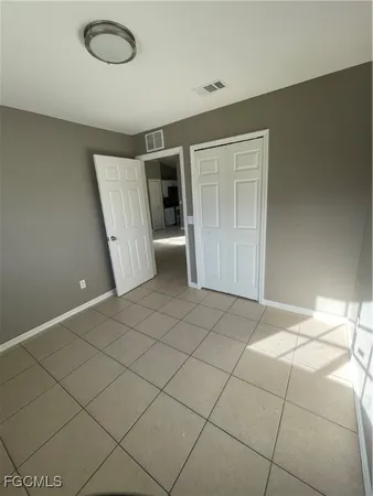 an empty room with a empty space and windows