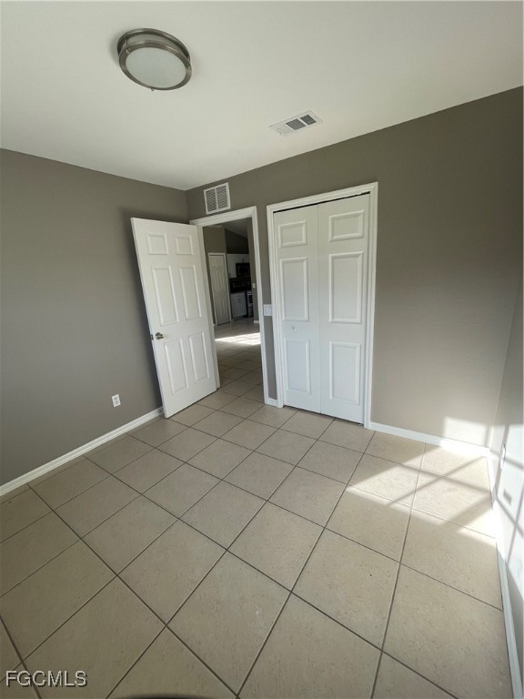 4718 28th Street Southwest Lehigh Acres, FL 33973 - Photo 11 of 12 an empty room with a empty space and windows