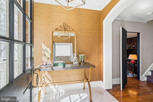 a living room with furniture a rug and a large window