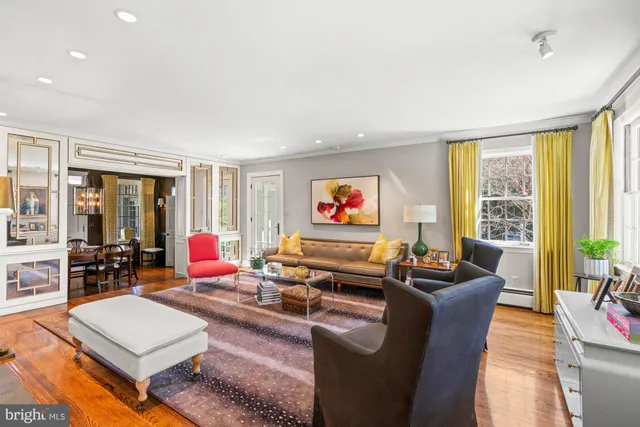 a dining room with furniture a chandelier and wooden floor