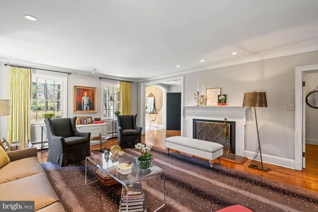 a dining room with furniture a chandelier and wooden floor