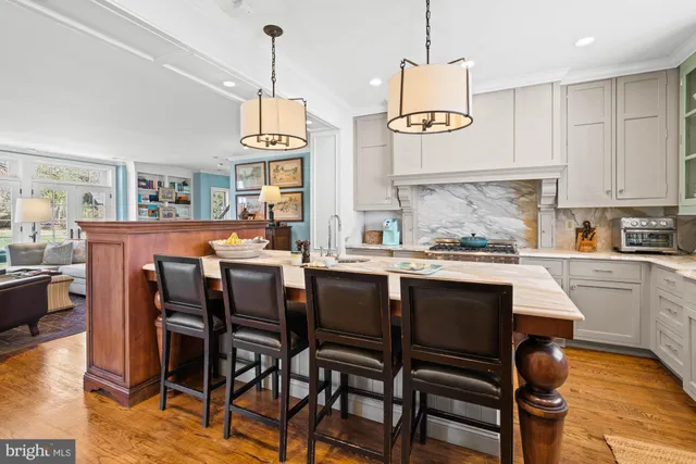 a view of a hallway with wooden floor and windows
