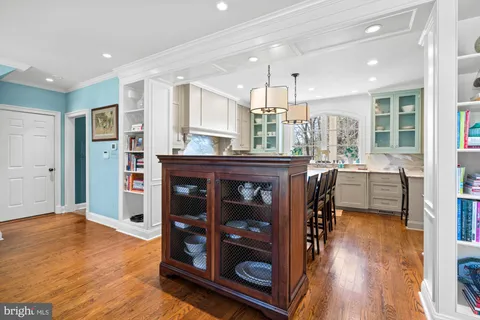 a spacious bedroom with a bed a table and large mirror