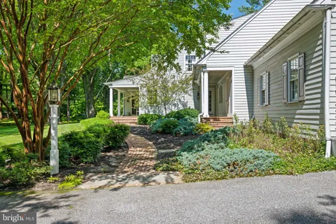 a living room with furniture a rug and a window