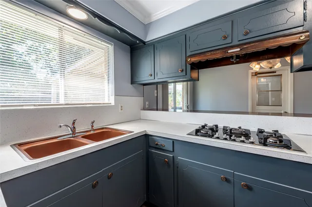 a kitchen with a sink cabinets and window