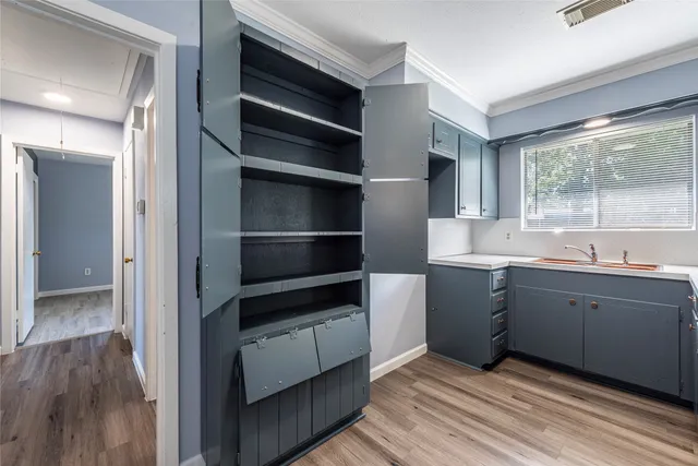 a view of kitchen with wooden floor and electronic appliances