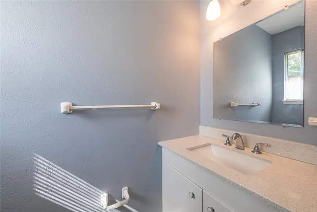a bathroom with a sink and vanity