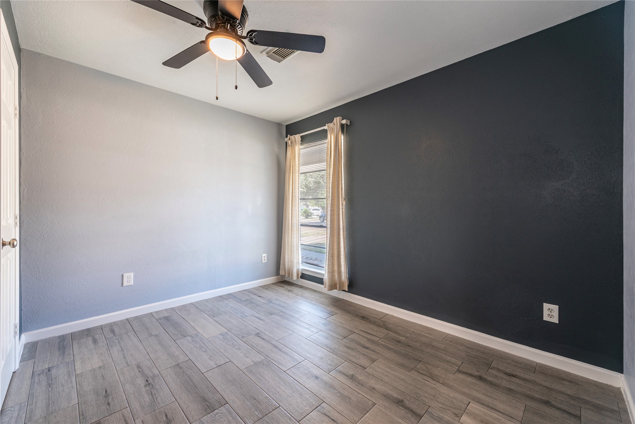 10914 Keese Drive Houston, TX 77089 - Photo 20 of 22 a view of an empty room with window and wooden floor