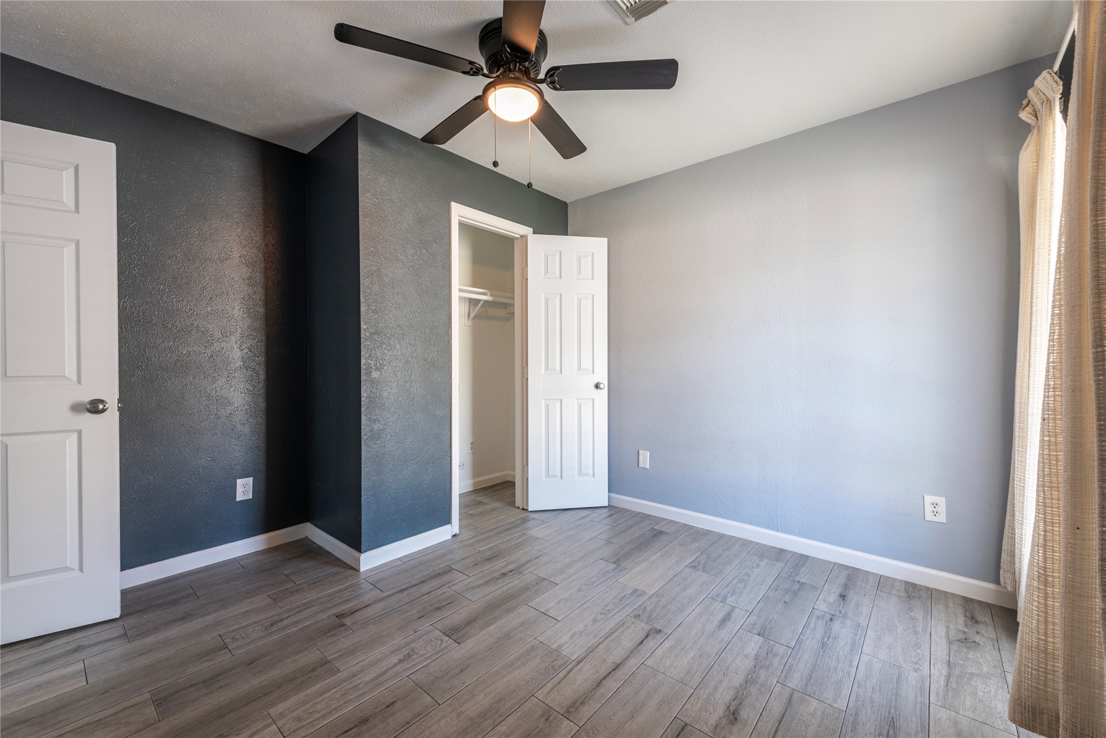 10914 Keese Drive Houston, TX 77089 - Photo 21 of 22 wooden floor in an empty room with a window