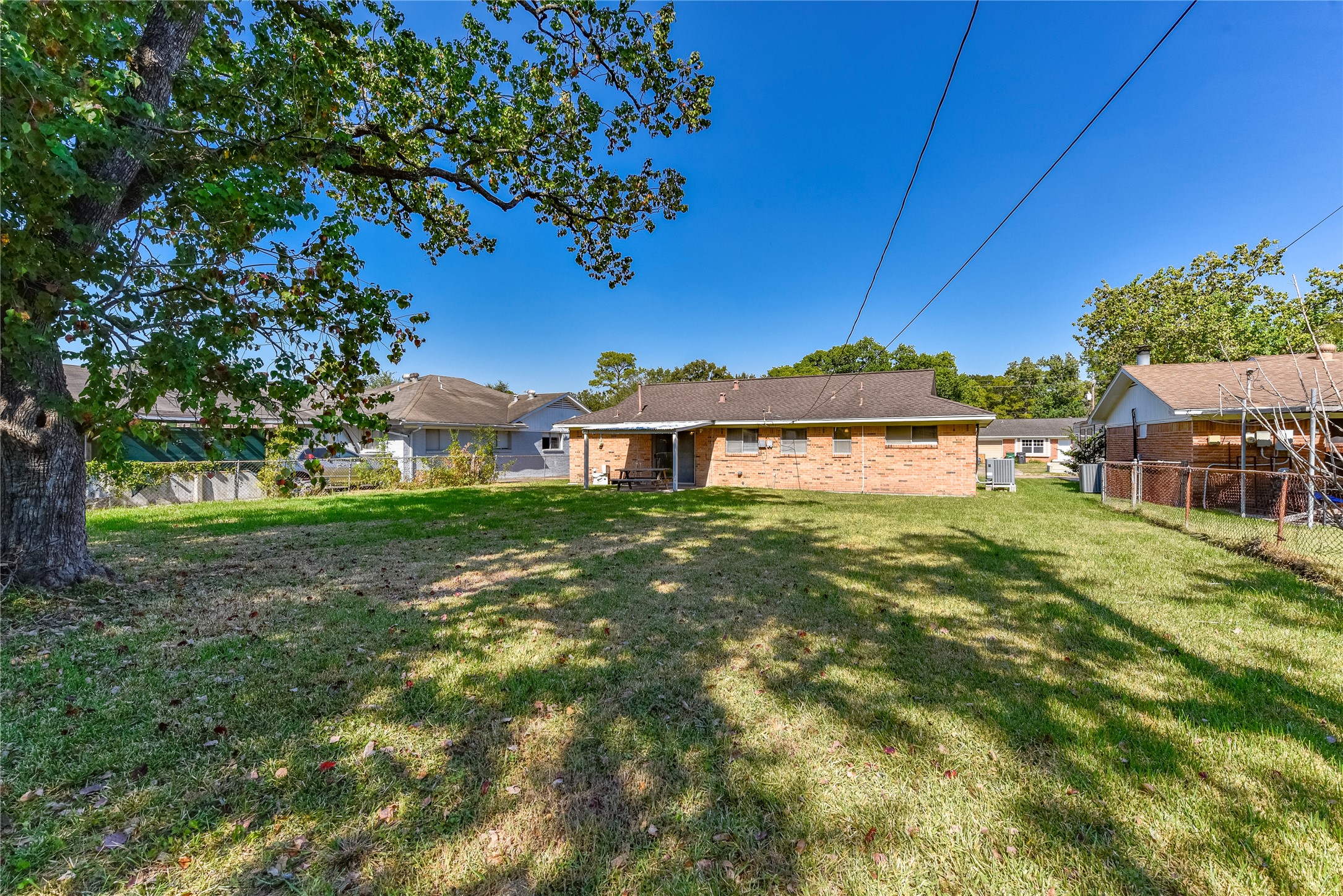 10914 Keese Drive Houston, TX 77089 - Photo 6 of 22 a view of a house with a big yard potted plants and large tree