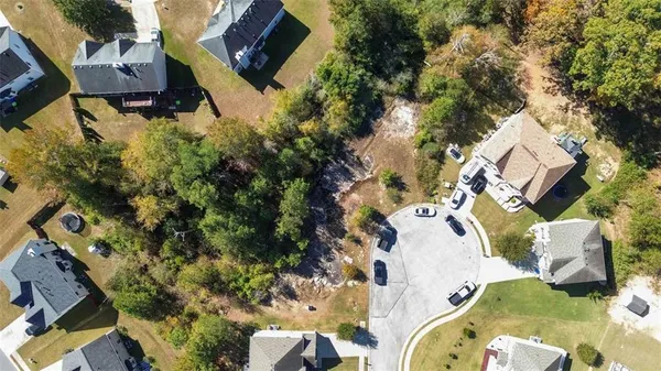 an aerial view of a house with a yard and trees